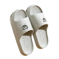 Pair of gray cartoon-patterned slide sandals.
