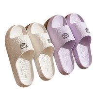 White and purple cartoon-themed slippers.