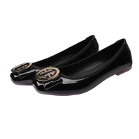 Black patent leather ballet flats with gold buckle.
