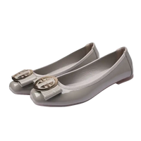 Gray patent leather ballet flats with gold buckle.