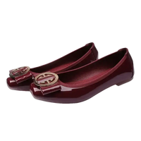 Burgundy patent leather ballet flats with gold buckle.