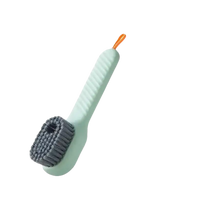 Green cleaning brush with handle.