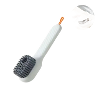 White cleaning brush with gray bristles.