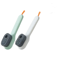 Two-piece white and green cleaning brushes.