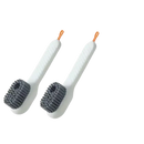 Two white shoe cleaning brushes.
