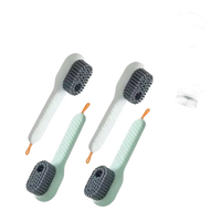 Four white and green cleaning brushes.