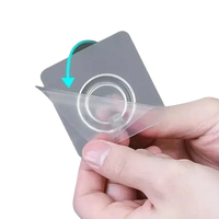 Adhesive wall hook with protective film being peeled.