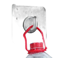 Adhesive wall hook holding water bottle.
