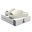 Cream-colored slide sandals.
