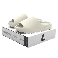 Cream-colored slide sandals.