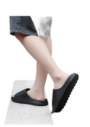 Black slip-on sandals.