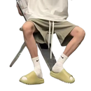 Person wearing slides and socks.