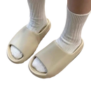 Beige slide sandals with white socks.