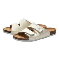 Pair of white slide sandals.