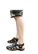 Black leather fisherman sandals.