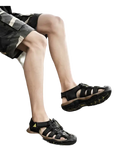 Black leather fisherman sandals.