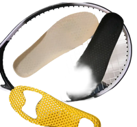 Shoe insoles on a tennis racket.