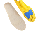 Shoe insoles with yellow honeycomb pattern.