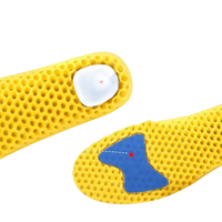 Yellow honeycomb insoles with blue damping pads.