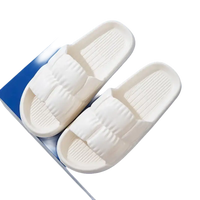 Pair of white textured slide sandals.