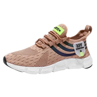 Beige athletic shoe with white sole.
