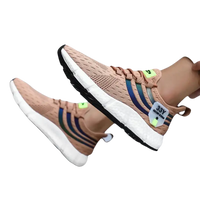 Tan athletic shoes with white soles.