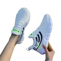 White athletic shoes with black stripes.
