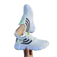 White athletic shoes with black stripes.