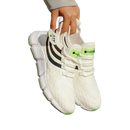 White athletic shoes with black stripes.