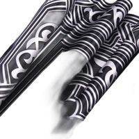 Black fabric with silver art deco pattern.