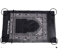 Black prayer mat with white design.