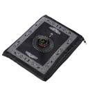 Black prayer mat with compass.