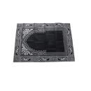 Black prayer mat with white geometric design.