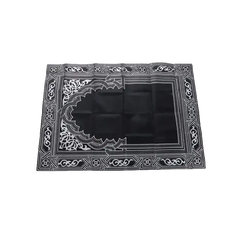 Black prayer mat with white geometric design.