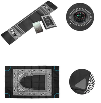 Black prayer mat with compass and iron corner weights.