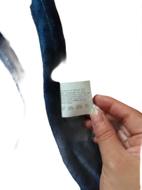 Blue velvet fabric with care tag.