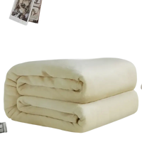 Folded, soft, cream-colored blanket.