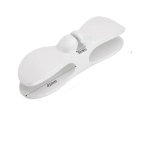 White plastic clip with dimensions.
