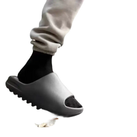 Gray slide sandals with black socks.