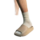 Tan-colored slide sandals with white socks.