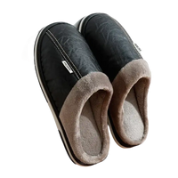 Pair of black leather-look slippers with gray plush lining.
