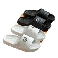 Black and white bear-themed slide sandals.
