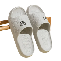 White cartoon-patterned slide sandals.