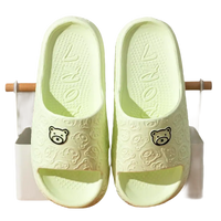 Green bear-themed slide sandals.
