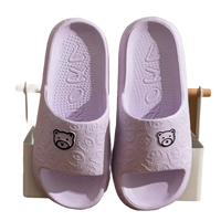 Pair of lavender bear-themed slide sandals.