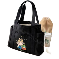 Black canvas tote bag with cartoon design.