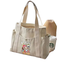 Canvas tote bag with cartoon graphic.