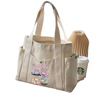 Cream-colored canvas tote bag with cartoon graphic.