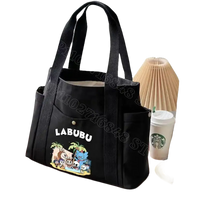 Black canvas tote bag with cartoon graphic.