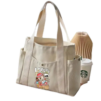 Canvas tote bag with cartoon graphic.